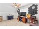 Home office area features hexagonal wall decorations, carpeted floors, and ceiling fan at 655 Mock Mill Rd, Statesville, NC 28677