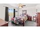 Bedroom boasts a cozy bed, neutral carpet, and a bright window with dark curtains at 655 Mock Mill Rd, Statesville, NC 28677