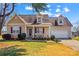 Charming single-Gathering home featuring a two-car garage, a covered porch, and well-maintained landscaping at 655 Mock Mill Rd, Statesville, NC 28677