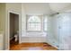 Bright bathroom featuring a soaking tub with window view, glass shower, and vanity at 6916 Sardis Green Ct, Charlotte, NC 28270