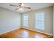 Bedroom featuring two windows for natural light, hardwood floors, and a ceiling fan at 6916 Sardis Green Ct, Charlotte, NC 28270
