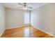 Bedroom with light-colored walls, ceiling fan, hardwood floors, and a window for natural light at 6916 Sardis Green Ct, Charlotte, NC 28270
