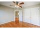 Bedroom featuring hardwood floors, a ceiling fan, and closet space at 6916 Sardis Green Ct, Charlotte, NC 28270