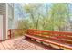 Wooden deck with built-in bench overlooking a lush green backyard and natural landscape at 6916 Sardis Green Ct, Charlotte, NC 28270