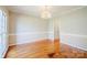 Well-lit dining room featuring hardwood floors, chair rail detail, and a view to the front yard at 6916 Sardis Green Ct, Charlotte, NC 28270