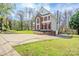 Brick and siding home boasts an attached garage and driveway, complemented by a lush green lawn at 6916 Sardis Green Ct, Charlotte, NC 28270