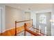 Bright foyer featuring a staircase with wood railings, hardwood floors, and a large window at 6916 Sardis Green Ct, Charlotte, NC 28270