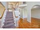 Spacious foyer featuring hardwood floors, staircase, and elegant archways leading to other rooms at 6916 Sardis Green Ct, Charlotte, NC 28270