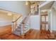 Inviting foyer with hardwood floors, staircase with white railings, and a chandelier, creating an elegant entrance at 6916 Sardis Green Ct, Charlotte, NC 28270