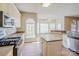 Bright kitchen with modern appliances, a center island, and a breakfast nook with large windows at 6916 Sardis Green Ct, Charlotte, NC 28270