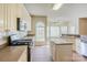 Bright kitchen with modern appliances, a center island, and a breakfast nook with large windows at 6916 Sardis Green Ct, Charlotte, NC 28270