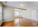 Light-filled living room with hardwood floors, a bay window, and access to outdoor area at 6916 Sardis Green Ct, Charlotte, NC 28270