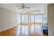 Bright living room with hardwood floors, a wall of windows, and a modern fireplace at 6916 Sardis Green Ct, Charlotte, NC 28270