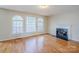 Bright living room with hardwood floors, fireplace, and large windows providing plenty of natural light at 6916 Sardis Green Ct, Charlotte, NC 28270