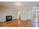 Inviting living room with hardwood floors, a fireplace, and views into a pantry and the home's entrance at 6916 Sardis Green Ct, Charlotte, NC 28270