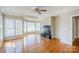 Bright living room featuring a fireplace, hardwood floors, and lots of natural light from large windows at 6916 Sardis Green Ct, Charlotte, NC 28270