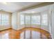 Bright living room with beautiful hardwood floors and bay windows offering abundant natural light at 6916 Sardis Green Ct, Charlotte, NC 28270