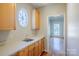 Functional pantry with ample cabinet space, a sink, and a round window offering natural light at 6916 Sardis Green Ct, Charlotte, NC 28270