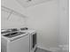 Laundry room with modern washer and dryer and wire shelving at 7030 Baldcypress Ter, Fort Mill, SC 29707