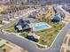 Aerial view featuring a swimming pool, clubhouse, playground, and sidewalks within a vibrant community at 7056 Cornwallis Ct, Iron Station, NC 28080