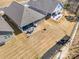 Aerial view highlights a backyard with a covered patio and grilling area in a gated community at 7056 Cornwallis Ct, Iron Station, NC 28080