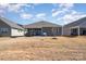 Expansive backyard featuring a covered patio with outdoor dining and grilling space, ideal for entertaining at 7056 Cornwallis Ct, Iron Station, NC 28080