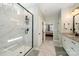 Bathroom featuring a tiled walk-in shower, double vanity, and access to an adjacent bedroom at 7056 Cornwallis Ct, Iron Station, NC 28080