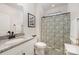 Bright bathroom featuring granite counters, a toilet, a sink, and a shower with a curtain at 7056 Cornwallis Ct, Iron Station, NC 28080