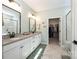 Modern bathroom with double vanity, marble floors, and a walk-in closet at 7056 Cornwallis Ct, Iron Station, NC 28080