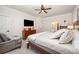 Bedroom showcasing bed, dresser, television, sitting chair, and a view into en suite bathroom at 7056 Cornwallis Ct, Iron Station, NC 28080