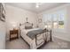 Comfortable bedroom showcasing a decorative bed frame, neutral walls, and ample natural light at 7056 Cornwallis Ct, Iron Station, NC 28080