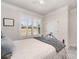 Bedroom featuring a decorative bed frame, neutral walls, and ample natural light at 7056 Cornwallis Ct, Iron Station, NC 28080