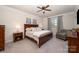 Cozy bedroom featuring a large bed, neutral color palette, and a sitting area near the window at 7056 Cornwallis Ct, Iron Station, NC 28080