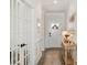 Inviting hallway features beautiful trim work, a console table, and a stylish front door with decorative glass at 7056 Cornwallis Ct, Iron Station, NC 28080