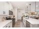Modern kitchen featuring sleek countertops, stainless steel appliances, and an adjacent dining area with natural light at 7056 Cornwallis Ct, Iron Station, NC 28080