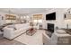 Cozy living room featuring a fireplace, plush seating, a large screen television, and natural light at 7056 Cornwallis Ct, Iron Station, NC 28080