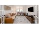 Living room with leather sofa, area rug, television, and workstation at 7056 Cornwallis Ct, Iron Station, NC 28080