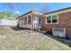 Charming brick home featuring a sunroom and a well-maintained lawn at 737 Waverly Pl, Statesville, NC 28677