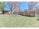Expansive backyard with mature trees, outbuilding, and well-maintained lawn at 737 Waverly Pl, Statesville, NC 28677