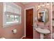 Bathroom features sink, decorative mirror, and a window with natural light at 737 Waverly Pl, Statesville, NC 28677