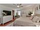 Tranquil bedroom features hardwood floors, a ceiling fan and a large window at 737 Waverly Pl, Statesville, NC 28677