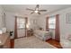 Cozy bedroom with ceiling fan, hardwood floors, area rug and matching pink curtains at 737 Waverly Pl, Statesville, NC 28677