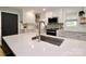 Updated kitchen features quartz countertops, stainless appliances, white cabinetry, and a stainless sink at 737 Waverly Pl, Statesville, NC 28677