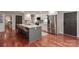 Modern kitchen with an island, stainless steel appliances, and hardwood flooring at 737 Waverly Pl, Statesville, NC 28677