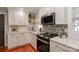 Modern kitchen features quartz counters, white cabinets, tile backsplash, and stainless appliances at 737 Waverly Pl, Statesville, NC 28677