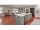 Updated kitchen with island, stainless dishwasher, eat-in dining area, and wood floors at 737 Waverly Pl, Statesville, NC 28677