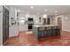 Bright, updated kitchen boasts stainless appliances, quartz countertops, and barstool seating at the island at 737 Waverly Pl, Statesville, NC 28677