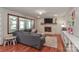 Bright living room with large windows, hardwood floors, and brick fireplace at 737 Waverly Pl, Statesville, NC 28677