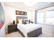 Bright bedroom featuring a wood bed frame, stylish decor, and abundant natural light from a large window at 7936 Cedarsmith Ct, Charlotte, NC 28217