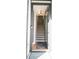 This entryway features a straight staircase with wood treads and metal railings at 7936 Cedarsmith Ct, Charlotte, NC 28217